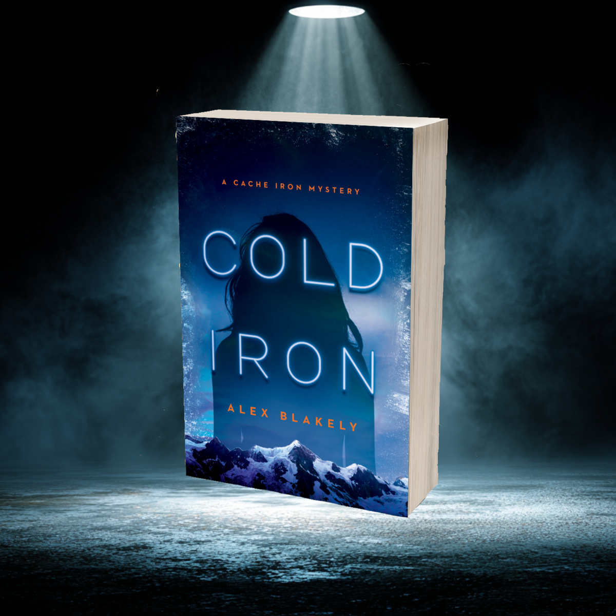 Paperback book titled 'Cold Iron' by Alex Blakely under a spotlight with a dark background